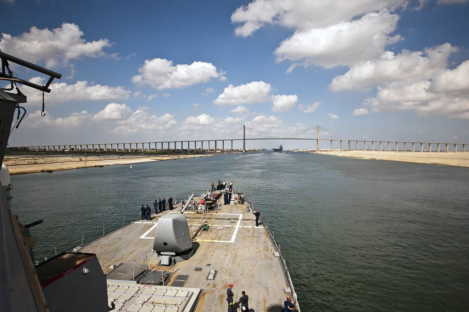 SUEZ CANAL (Oct. 12, 2012) The guided-missile destroyer USS Porter (DDG 78) and the aircraft carrier USS Enterprise (CVN 65) cross under the Friendship Bridge in the Suez Canal. Porter is returning from a deployment to the U.S. 5th Fleet area of responsibility, where the ship conducting maritime security operations, theater security cooperation efforts and support missions for Operation Enduring Freedom. (U.S. Navy photo by Mass Communication Specialist 2nd Class Alex R. Forster/Released) 121012-N-WO496-006 Join the conversation www.facebook.com/USNavy www.twitter.com/USNavy navylive.dodlive.mil