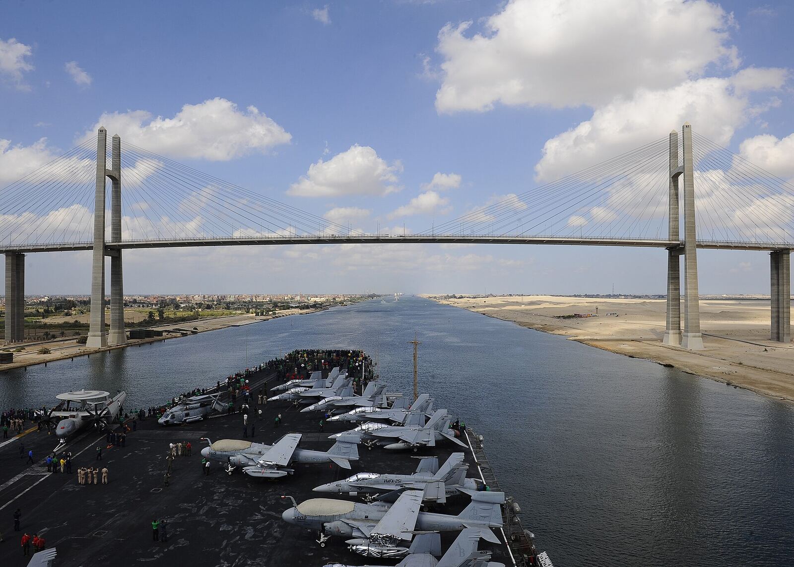 SUEZ CANAL (Oct. 12, 2012) The aircraft carrier USS Enterprise (CVN 65) passes underneath the Friendship Bridge while moving through the Suez Canal. Enterprise was deployed to the U.S. 5th Fleet area of responsibility conducting maritime security operations, theater security cooperation efforts and support missions for Operation Enduring Freedom. The U.S. Navy is reliable, flexible, and ready to respond worldwide on, above, and below the sea. Join the conversation on social media using #warfighting. (U.S. Navy photo by Mass Communication Specialist 3rd Class Scott Pittman/Released) 121012-N-FI736-159 Join the conversation www.facebook.com/USNavy www.twitter.com/USNavy navylive.dodlive.mil