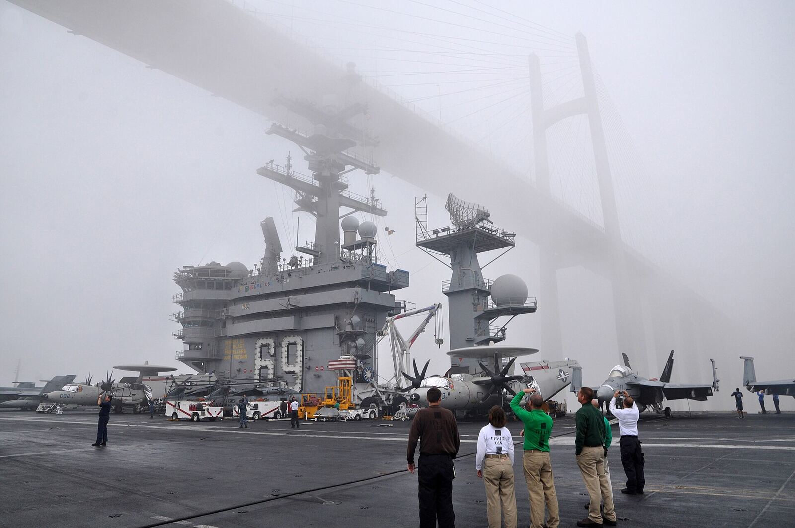 SUEZ CANAL (July 18, 2012) Sailors stand on the flight deck as the aircraft carrier USS Dwight D. Eisenhower (CVN 69) passes under the Friendship Bridge while transiting the Suez Canal. Dwight D. Eisenhower is deployed to the U.S. 5th Fleet area of responsibility conducting maritime security operations, theater security cooperation efforts and support missions as part of Operation Enduring Freedom. (U.S. Navy photo by Mass Communication Specialist 1st Class Nathanael Miller/Released) 120718-N-YX169-009 Join the conversation www.facebook.com/USNavy www.twitter.com/USNavy navylive.dodlive.mil